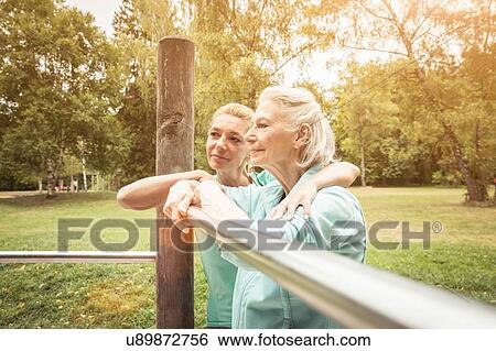 Women in park leaning against playground equipment looking away View Large Photo Image Stock Photograph - Women in park leaning against playground equipment looking away. Fotosearch
