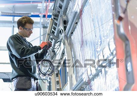 Worker fitting electrics on motorhome production line View Large Photo Image Picture - Worker fitting electrics on motorhome production line. Fotosearch