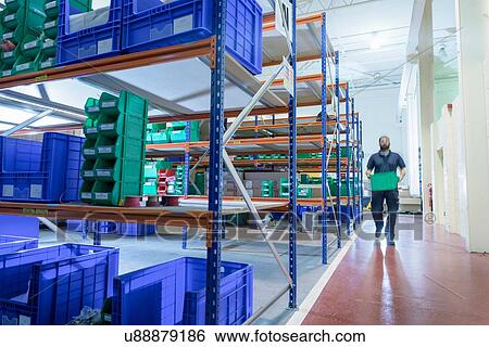 Worker in storage area of electronics factory View Large Photo Image Stock Photograph - Worker in storage area of electronics factory. Fotosearch
