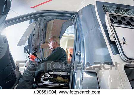 Picture - Worker on motorhome production line. Fotosearch