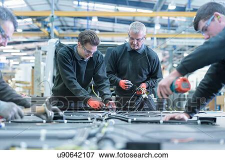 Stock Photo - Workers on motorhome production line. Fotosearch