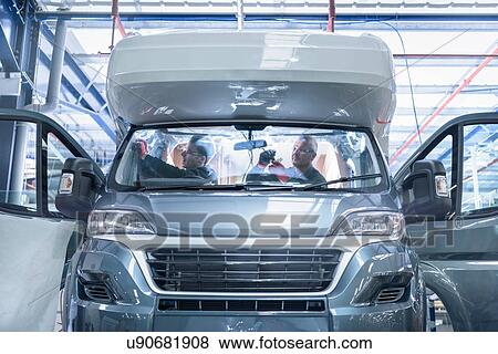 Stock Photo - Workers on motorhome production line. Fotosearch