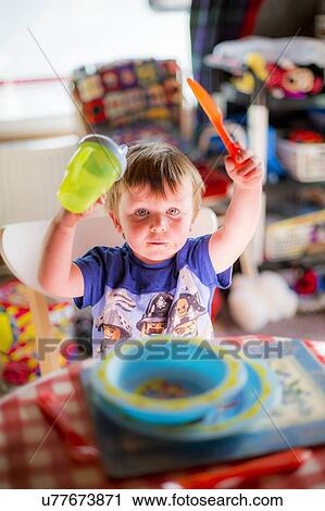 Young boy at the dinner table View Large Photo Image Stock Image - Young boy at the dinner table. Fotosearch