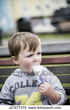 Stock Image - Young boy eating an ice cream. Fotosearch