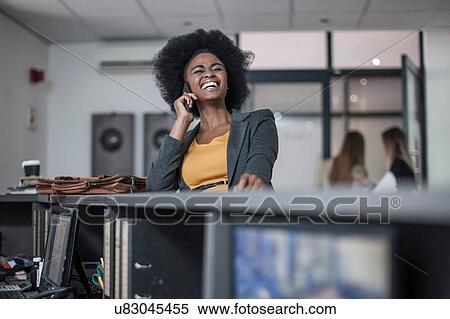 Young businesswoman chatting and laughing on at office reception View Large Photo Image Stock Photography - Young businesswoman chatting and laughing on at office reception. Fotosearch