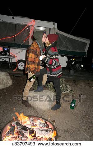 "Young couple by camp-fire, kissing" View Large Photo Image Stock Image - "Young couple by camp-fire, kissing". Fotosearch