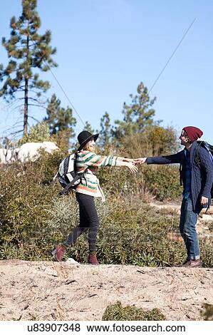 Stock Photo - Young couple fooling around in rural setting. Fotosearch