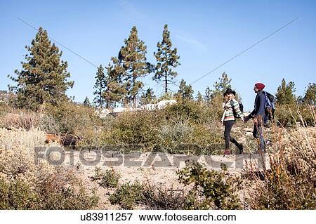 Stock Photo - "Young couple in rural setting, hiking". Fotosearch
