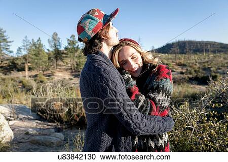 "Young couple in rural setting, hugging" View Large Photo Image Stock Image - "Young couple in rural setting, hugging". Fotosearch
