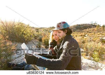 "Young couple in rural setting, looking at map" View Large Photo Image Picture - "Young couple in rural setting, looking at map". Fotosearch