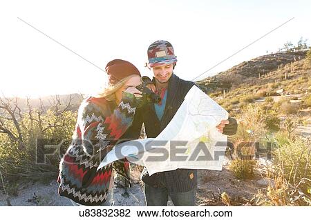 "Young couple in rural setting, looking at map, laughing" View Large Photo Image Stock Image - "Young couple in rural setting, looking at map, laughing". Fotosearch