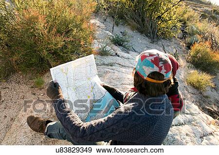 "Young couple in rural setting, looking at map, rear view" View Large Photo Image Stock Photo - "Young couple in rural setting, looking at map, rear view". Fotosearch