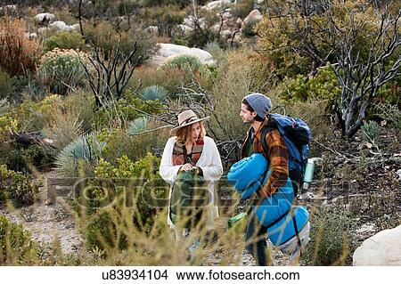 "Young couple in rural setting, carrying camping equipment" View Large Photo Image Picture - "Young couple in rural setting, carrying camping equipment". Fotosearch