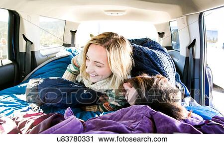 "Young couple lying down in recreational vehicle, fooling around, laughing" View Large Photo Image Stock Image - "Young couple lying down in recreational vehicle, fooling around, laughing". Fotosearch