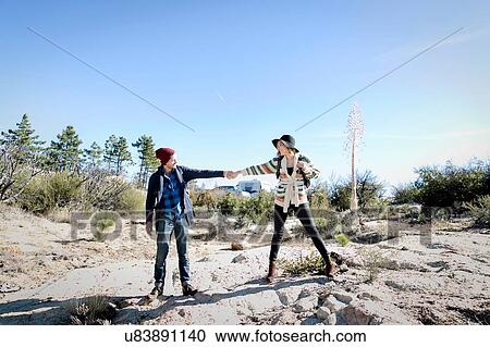 "Young couple outdoors, hiking, holding hands" View Large Photo Image Stock Image - "Young couple outdoors, hiking, holding hands". Fotosearch
