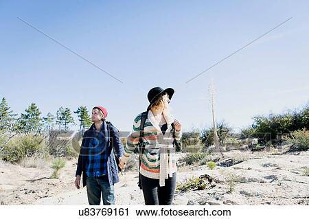 Stock Image - "Young couple outdoors, hiking". Fotosearch