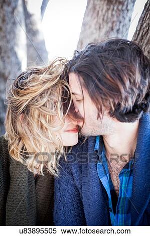 Stock Photography - "Young couple outdoors, kissing". Fotosearch