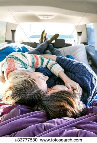 Stock Image - Young couple sleeping in recreational vehicle. Fotosearch