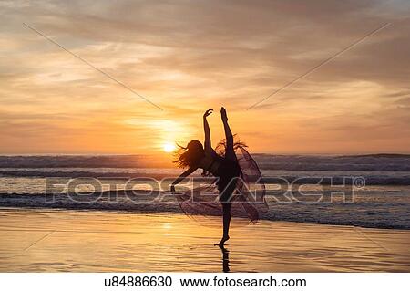 "Young female dancer wearing chiffon dress, dancing on beach at sunset, San Diego, California, USA" View Large Photo Image Stock Image - "Young female dancer wearing chiffon dress, dancing on beach at sunset, San Diego, California, USA". Fotosearch