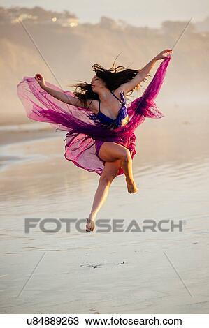"Young female dancer wearing chiffon dress, dancing on beach, San Diego, California, USA" View Large Photo Image Stock Image - "Young female dancer wearing chiffon dress, dancing on beach, San Diego, California, USA". Fotosearch