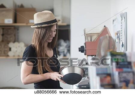 Young female waitress preparing food behind counter in cafe View Large Photo Image Stock Photograph - Young female waitress preparing food behind counter in cafe. Fotosearch