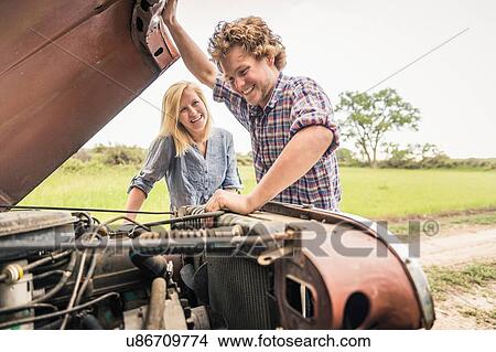 Young man and girlfriend checking jeep engine View Large Photo Image Picture - Young man and girlfriend checking jeep engine. Fotosearch