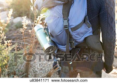 "Young man hiking in rural setting, rear view, mid section" View Large Photo Image Stock Image - "Young man hiking in rural setting, rear view, mid section". Fotosearch