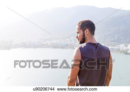 Picture - Young man looking at view, Rio de Janeiro, Brazil. Fotosearch