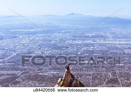 "Young man sitting on mountain top, Mount Baldy, California, USA" View Large Photo Image Stock Photograph - "Young man sitting on mountain top, Mount Baldy, California, USA". Fotosearch