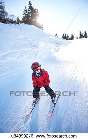 Young skier going downhill View Large Photo Image Stock Photograph - Young skier going downhill. Fotosearch