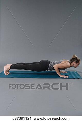 Young woman doing plank exercise, grey background View Large Photo Image Stock Image - Young woman doing plank exercise, grey background. Fotosearch