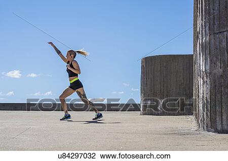 Young woman exercising outdoors View Large Photo Image Stock Image - Young woman exercising outdoors. Fotosearch