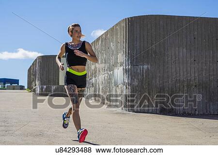"Young woman exercising, running, outdoors" View Large Photo Image Stock Photo - "Young woman exercising, running, outdoors". Fotosearch