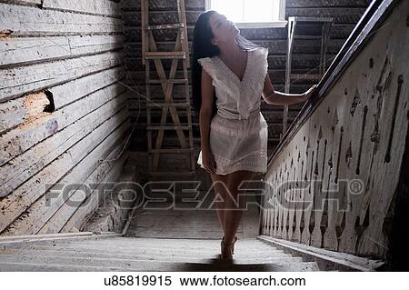 Young woman going up staircase View Large Photo Image Stock Photography - Young woman going up staircase. Fotosearch