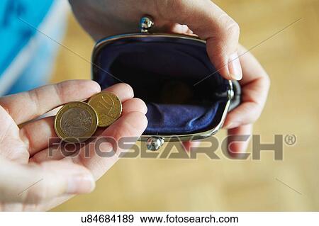"Young woman holding coins from purse, close-up" View Large Photo Image Stock Photo - "Young woman holding coins from purse, close-up". Fotosearch