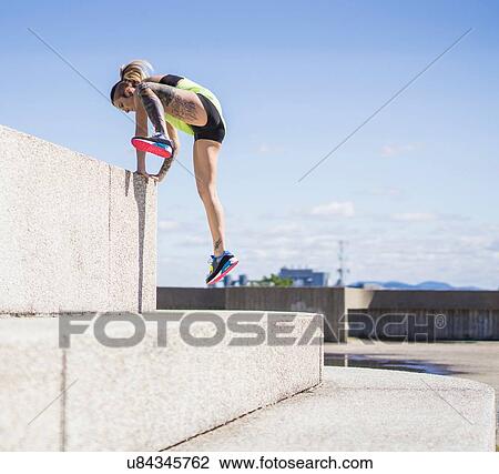 Young woman jumping up large concrete step View Large Photo Image Stock Image - Young woman jumping up large concrete step. Fotosearch