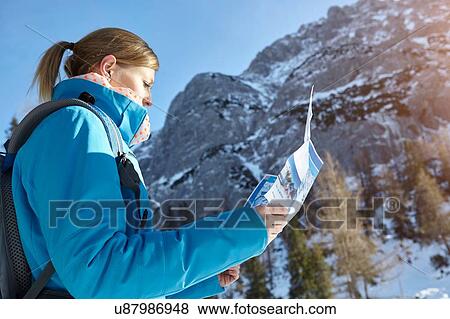 Young woman looking at map in Austrian mountains View Large Photo Image Stock Photo - Young woman looking at map in Austrian mountains. Fotosearch