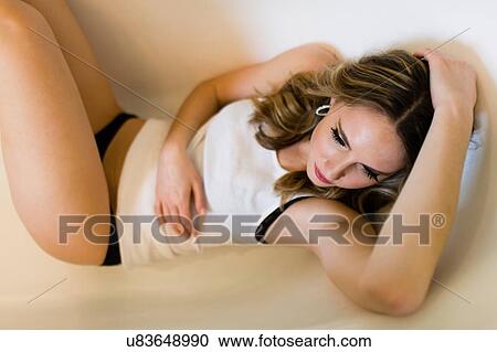 Young woman lying in bathtub View Large Photo Image Stock Image - Young woman lying in bathtub. Fotosearch