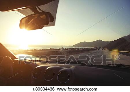 Young woman on the road driving pacific coast highway at sunset, California, USA View Large Photo Image Stock Photograph - Young woman on the road driving pacific coast highway at sunset, California, USA. Fotosearch
