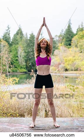 Young woman practicing yoga on forest lakeside View Large Photo Image Stock Photograph - Young woman practicing yoga on forest lakeside. Fotosearch