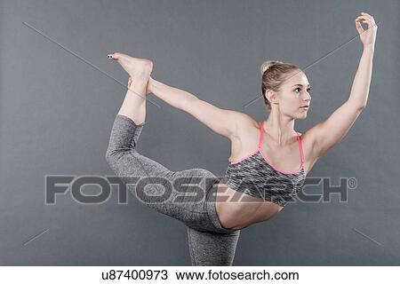 Young woman practising yoga, grey background View Large Photo Image Stock Image - Young woman practising yoga, grey background. Fotosearch