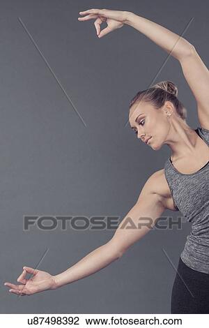 Young woman practising yoga, grey background View Large Photo Image Stock Image - Young woman practising yoga, grey background. Fotosearch