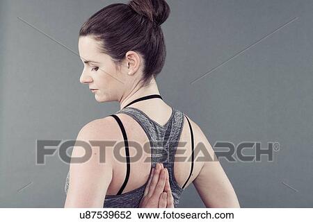 Young woman practising yoga, grey background View Large Photo Image Stock Image - Young woman practising yoga, grey background. Fotosearch