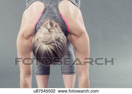 Young woman practising yoga, grey background View Large Photo Image Stock Image - Young woman practising yoga, grey background. Fotosearch