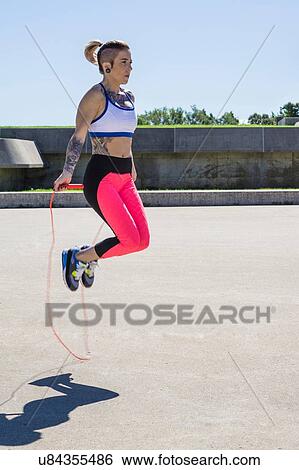 "Young woman skipping with rope, outdoors" View Large Photo Image Stock Photograph - "Young woman skipping with rope, outdoors". Fotosearch