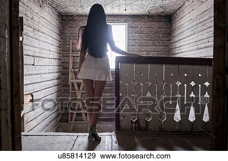 Young woman standing at top of staircase View Large Photo Image Stock Photo - Young woman standing at top of staircase. Fotosearch