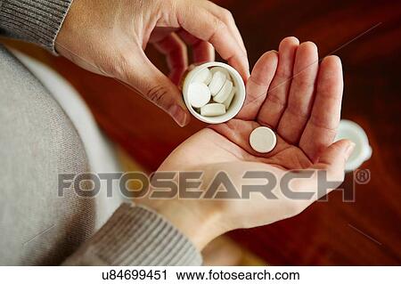 "Young woman taking medication from tub, close-up" View Large Photo Image Stock Image - "Young woman taking medication from tub, close-up". Fotosearch