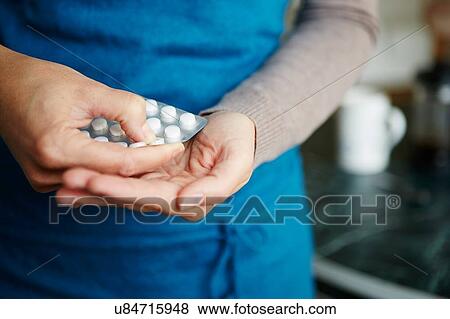 "Young woman taking medication from blister pack, close-up" View Large Photo Image Stock Photo - "Young woman taking medication from blister pack, close-up". Fotosearch