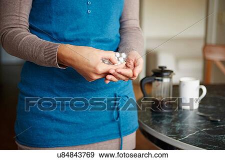 "Young woman taking medication from blister pack, close-up" View Large Photo Image Stock Photo - "Young woman taking medication from blister pack, close-up". Fotosearch