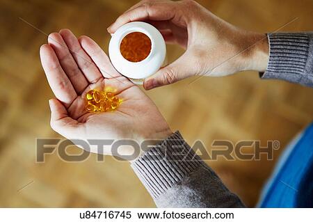 "Young woman taking medication from bottle, close-up" View Large Photo Image Stock Photography - "Young woman taking medication from bottle, close-up". Fotosearch
